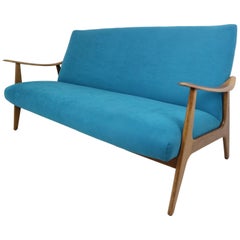 Used Danish design teak sofa newly upholstered in blue velvet