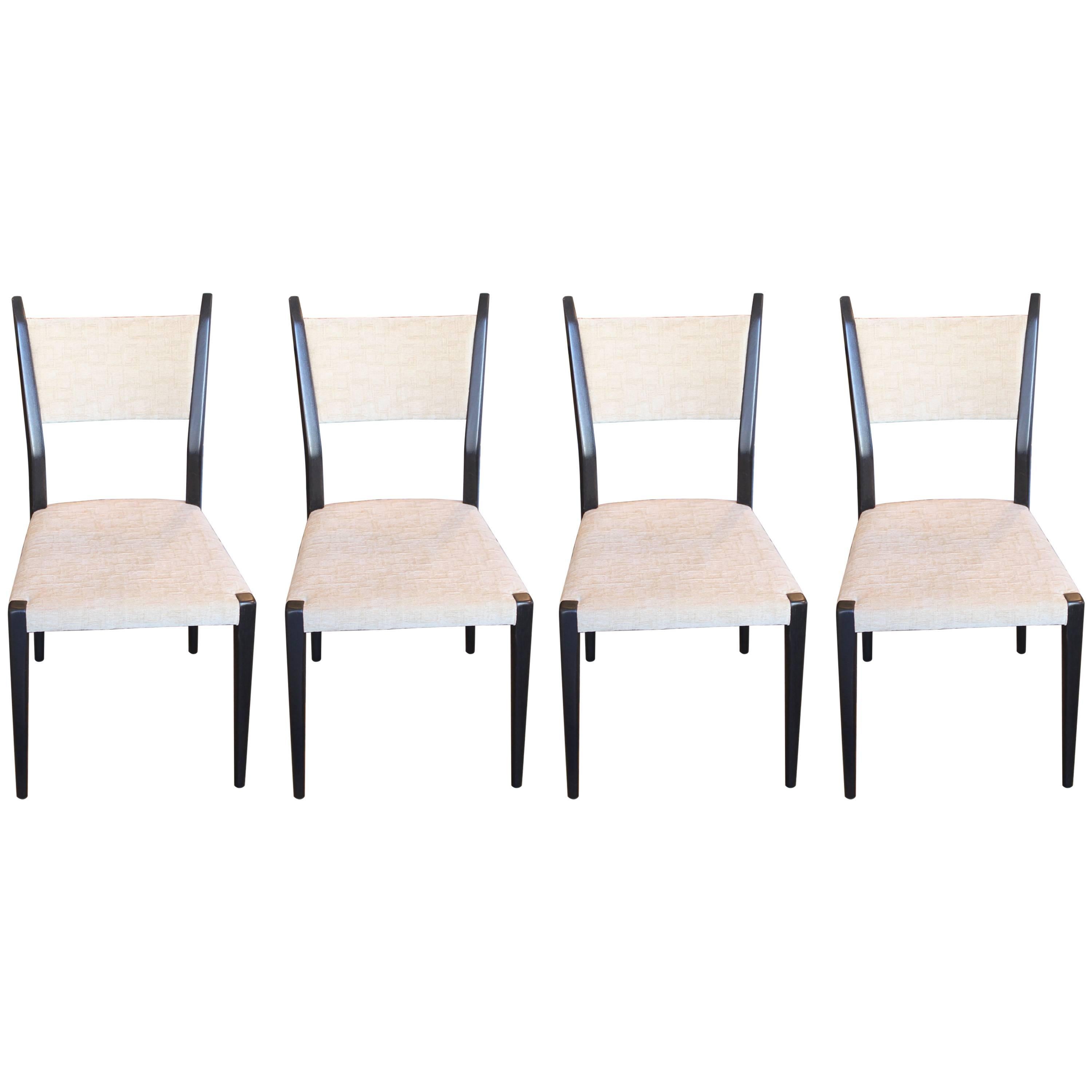 Modern set of four black and white sculptural dining chairs designed by Paul McCobb for Calvin. In original fabric white / cream textured fabric. The contrast between the black frame and light fabric create a nice dynamic. Perfect statement chairs