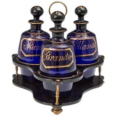 Antique Georgian Gilt and Black Lacquered Stand with Blue Barrel Decanters