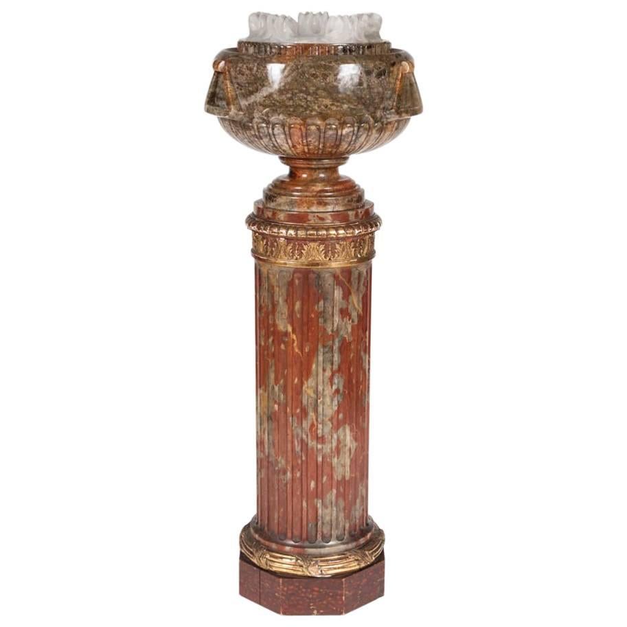 Bol en albâtre sculpté reposant sur une colonne cannelée, avec lumière