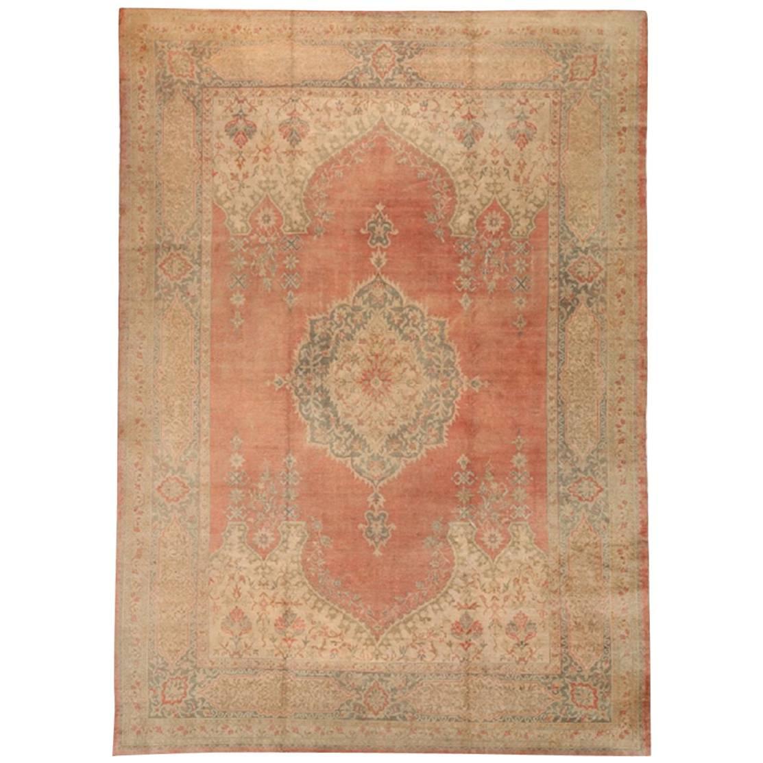 Antique Turkish Oushak, circa 1920 in Soft Orange/Red with Scalloped Medallion For Sale