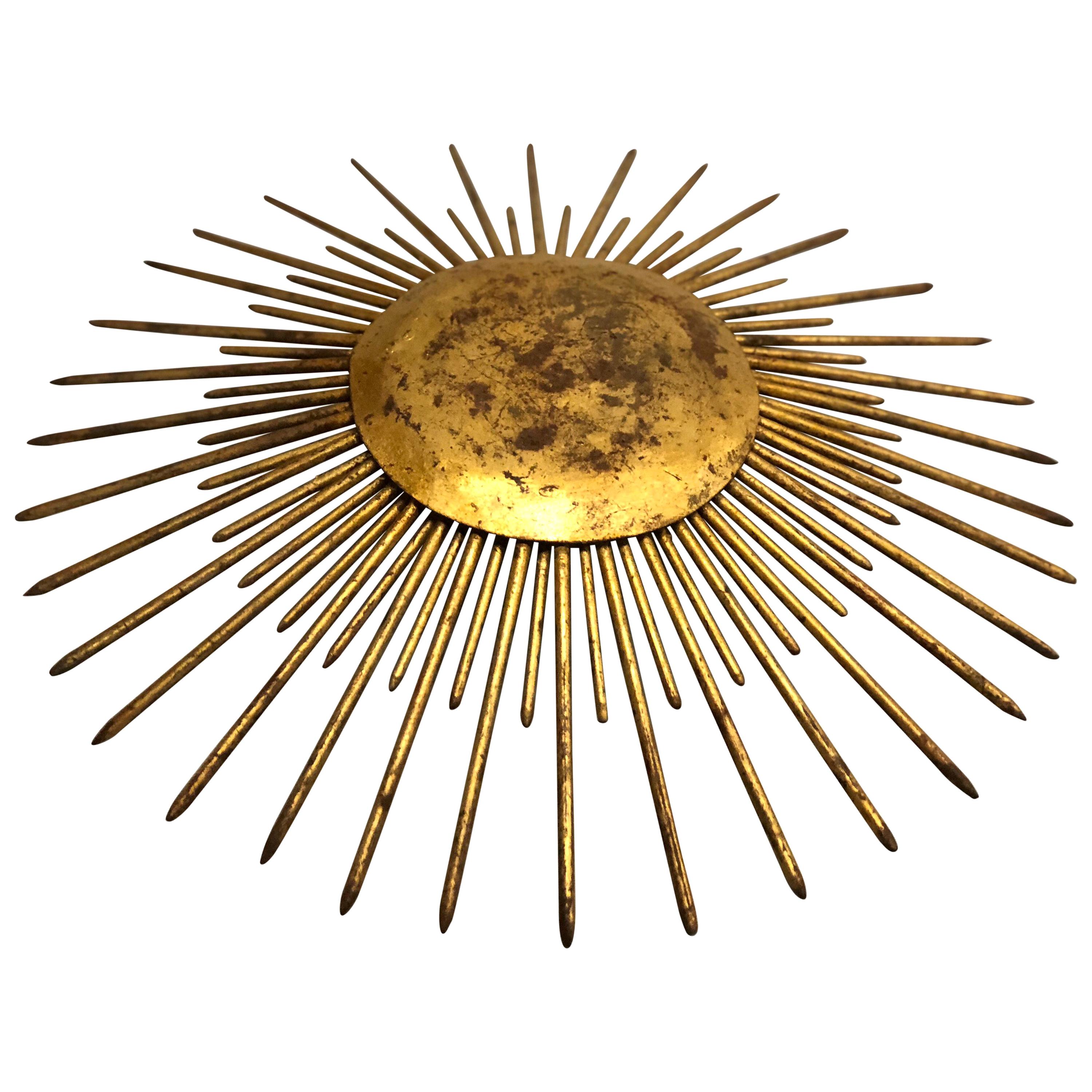French Mid-Century Modern neoclassical gilt iron sunburst flush mount fixture or pendant.

Authentic, original patina and an elegant form with two rows of iron spikes forming the basis of the sunburst or star burst around a gilt iron round central