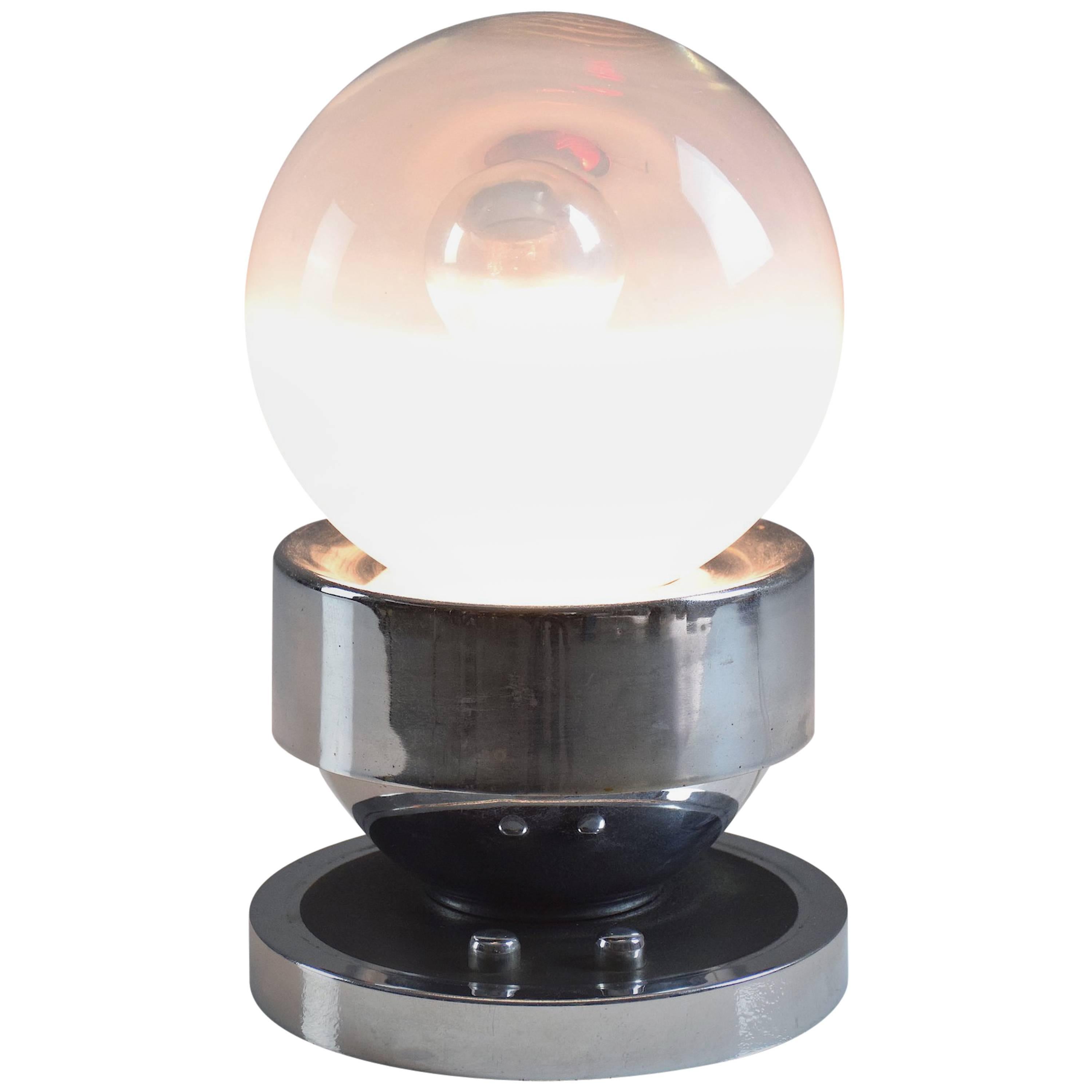 20th century vintage ball lamp composed of a chrome layered structure and a glass spherical shade. An original design with two-light push switches: one controls a white light and the other controls a red light.

 