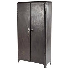 An Industrial Metal Cabinet with Unique Ball Handles and Interior Storage