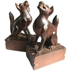 Paire de serre-livres du début de 1900 sculptés et stylisés à la main représentant des chiens jouant avec des fetchs