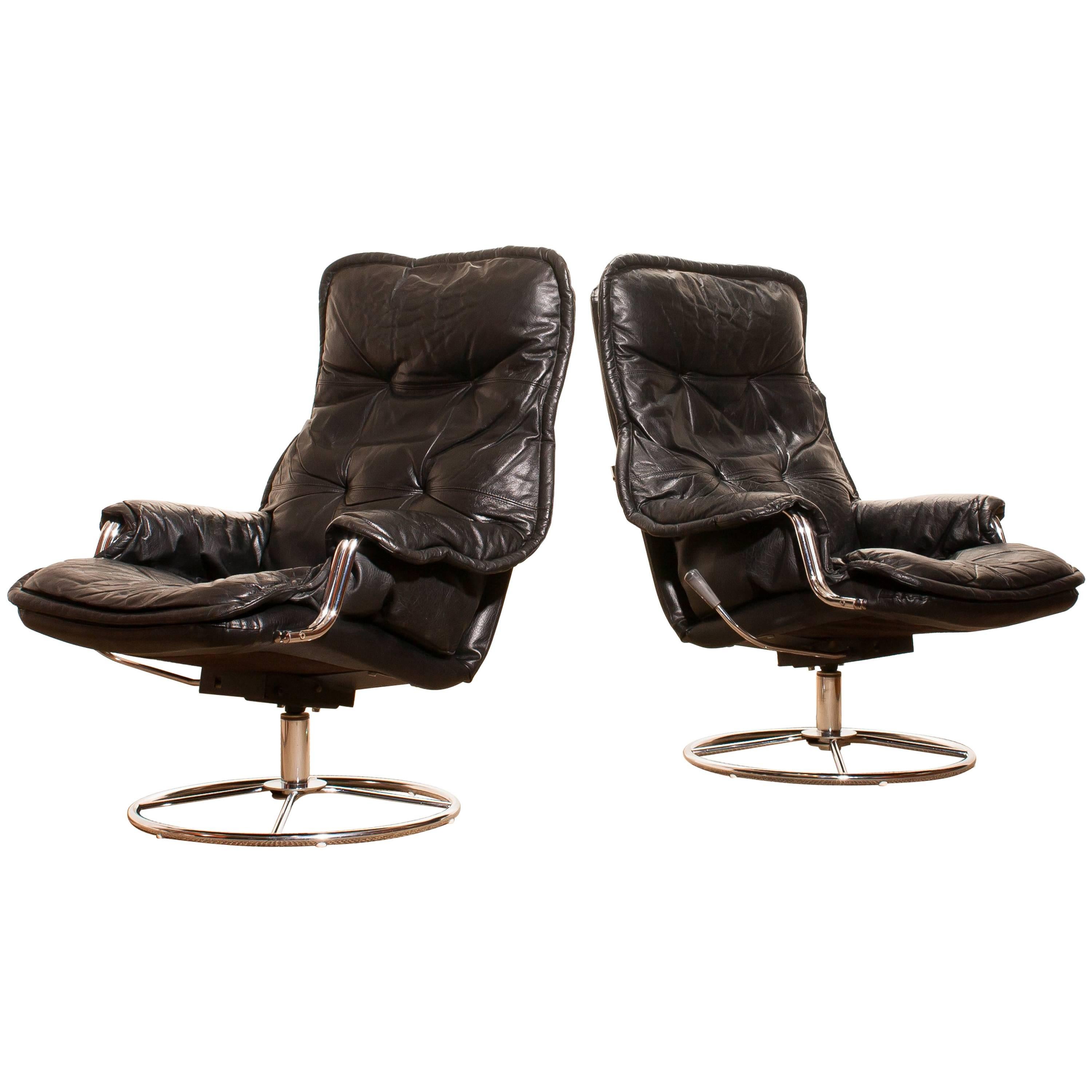 1970s, a Pair of Black Leather Swivel Chrome Steel Lounge Chairs , Sweden