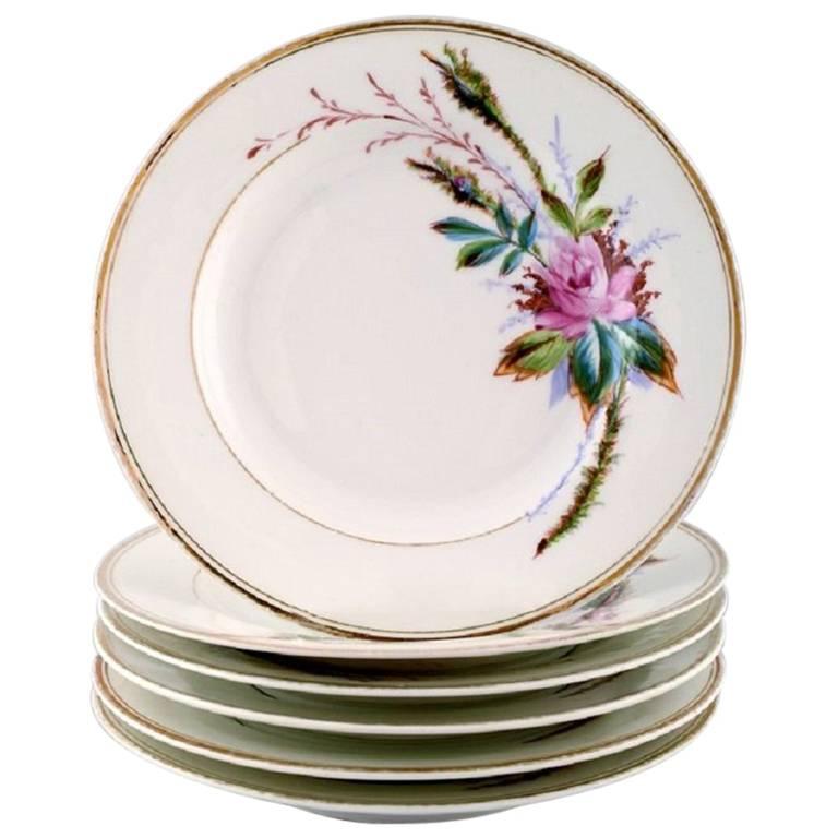 6 antique Royal Copenhagen plates hand decorated with flowers. App. 1850s