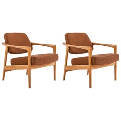 Folke Ohlsson 1960s lounge chairs in teak and natural fabric produced by Dux