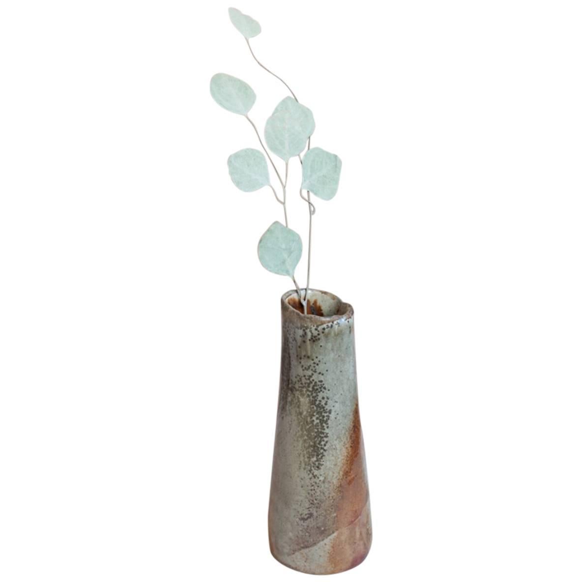 One of a kind organic modern hand-built tapered vase fired over several days in a Japanese-style Anagama-Noborigama wood-fire cross-draft kiln. Glaze goes from a metallic deep rust color to speckled grey.

Handmade wood-fired stoneware tapered