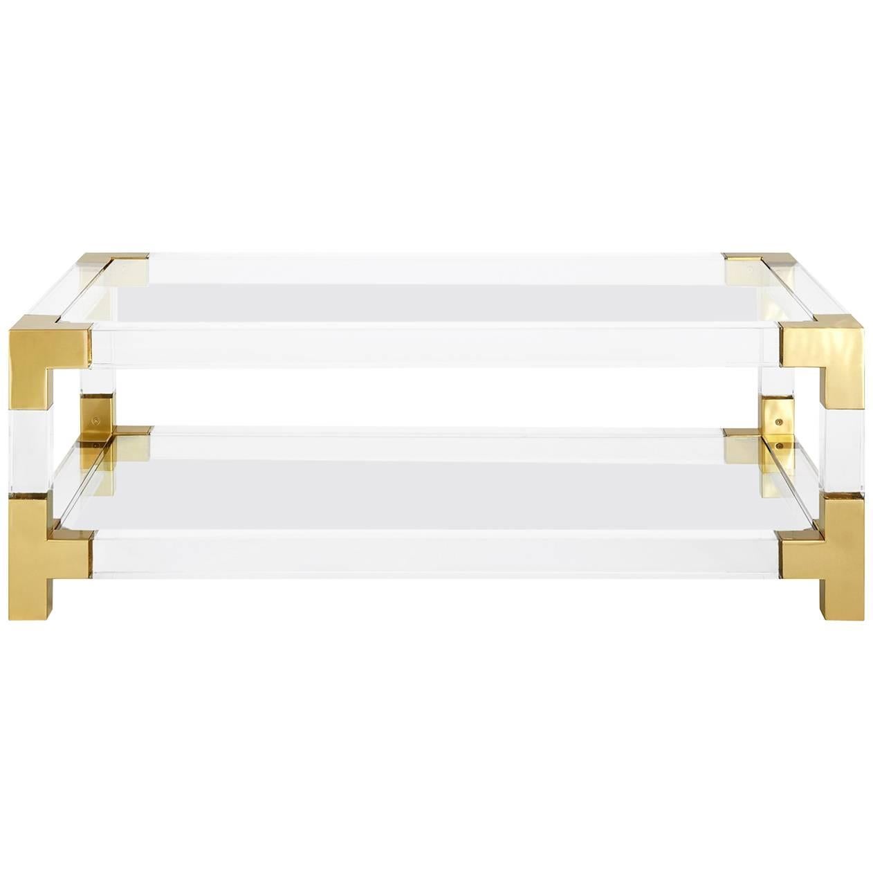 Clearly cool. Our Jacques collection is the perfect blend of simplicity and glamour, modern and traditional. In clear Lucite with brushed brass accents, it's low and lounge. The size is perfect for a sectional or grand sofa, while the second shelf