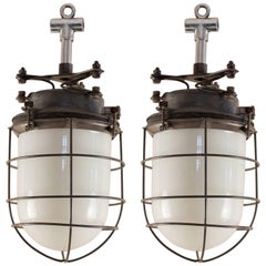 Retro Pair of Nautical or Industrial Milk Glass and Steel Caged Pendant Lights