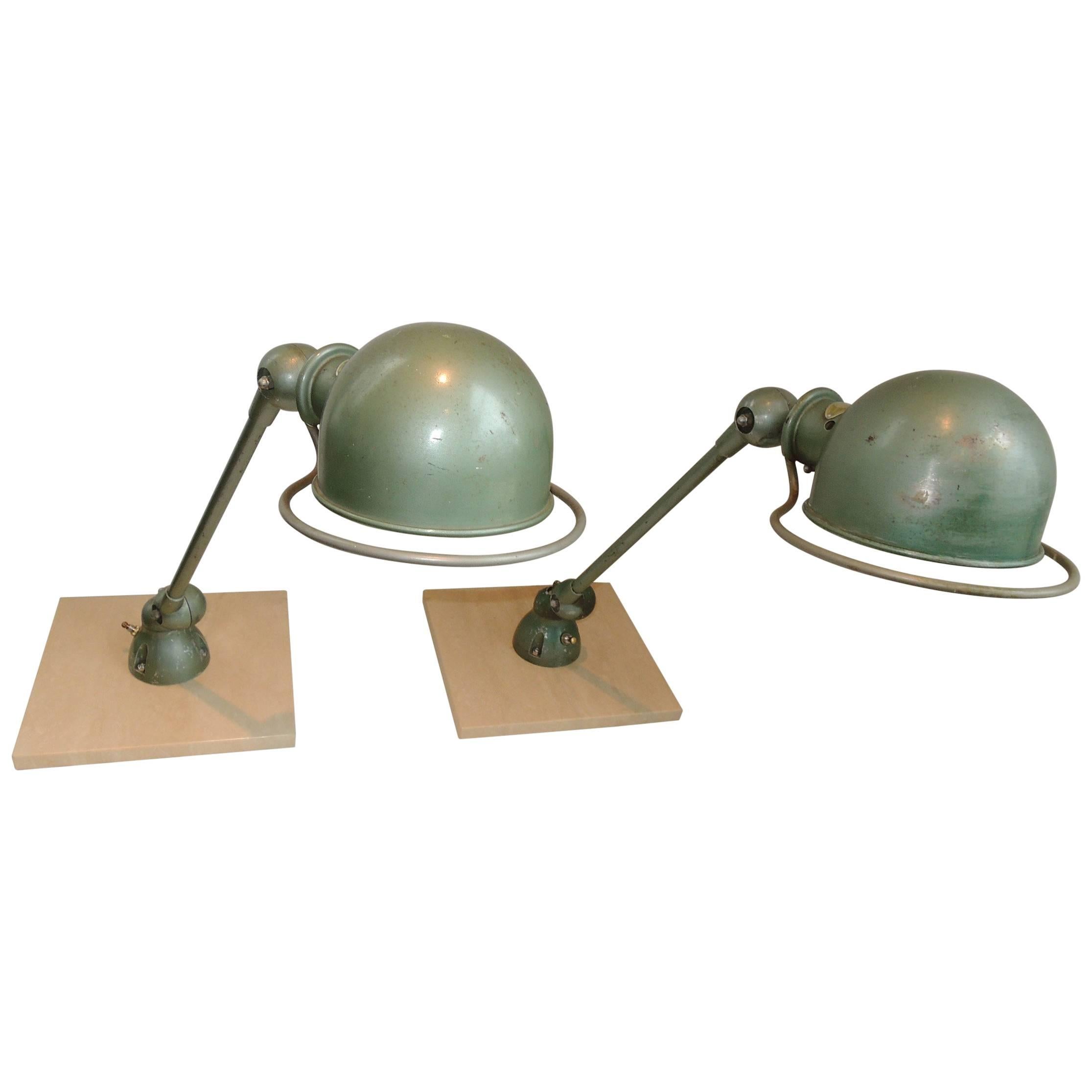 One-arm articulated industrial lamps designed by Jean-Louis Domecq, manufactured by Jeldé post WWII.
Strong, sturdy, highly functional. Originally meant to be screwed into a work table. Ours are rewired and mounted on travertine bases, 11