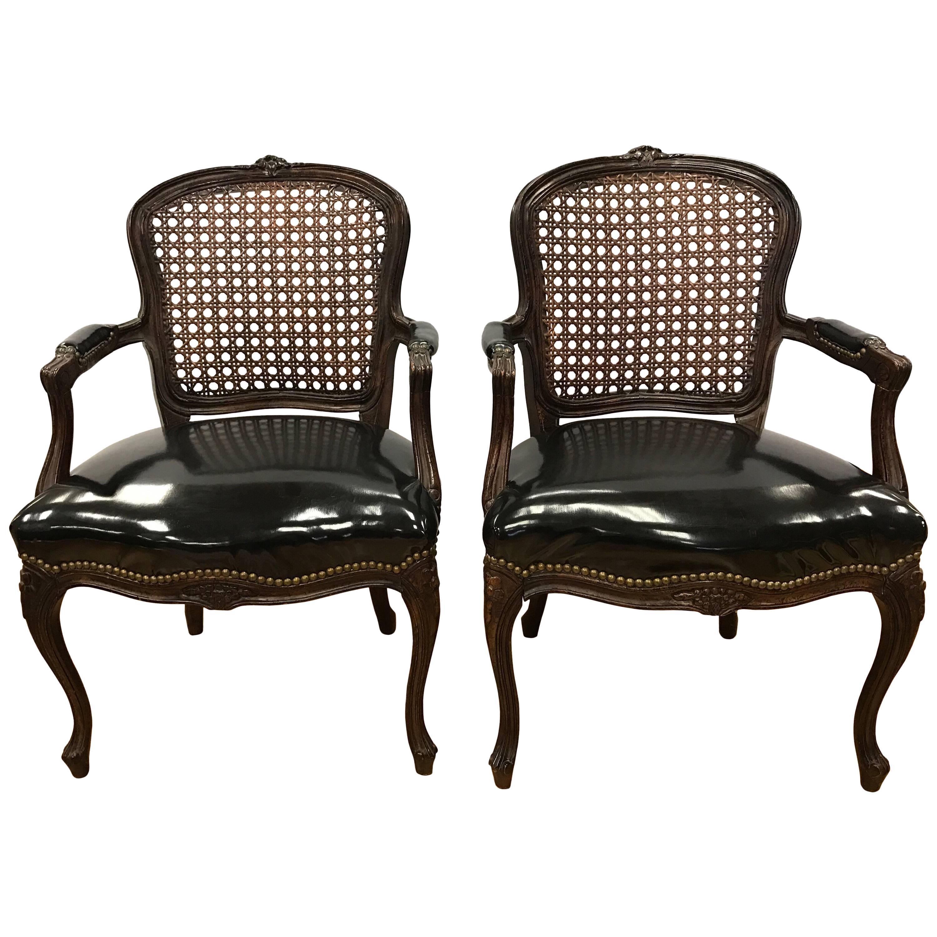 Pair of Cane Back French Louis XV Carved Chairs with Black Patent Leather Seats
