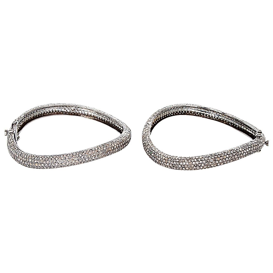 This bohemian style bangle set features a curve design with 13.0 ctw. diamonds set in oxidized sterling silver. This set is perfect for everyday wear and can go from day to night!  Can fit up to a 7-inch wrist. Total weight is 40.0 grams.