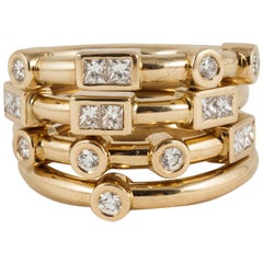 18k Yellow Gold and White Diamond Love Stacking Rings spelling "LOVE"