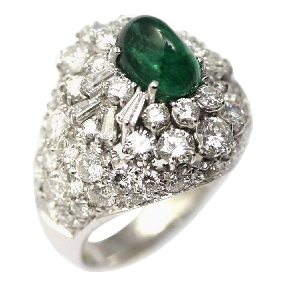 Dome ring set with 5 carats of diamonds and a 2.68 carats sugarloaf emerald For Sale