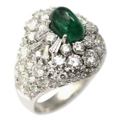 Dome ring set with 5 carats of diamonds and a 2.68 carats sugarloaf emerald