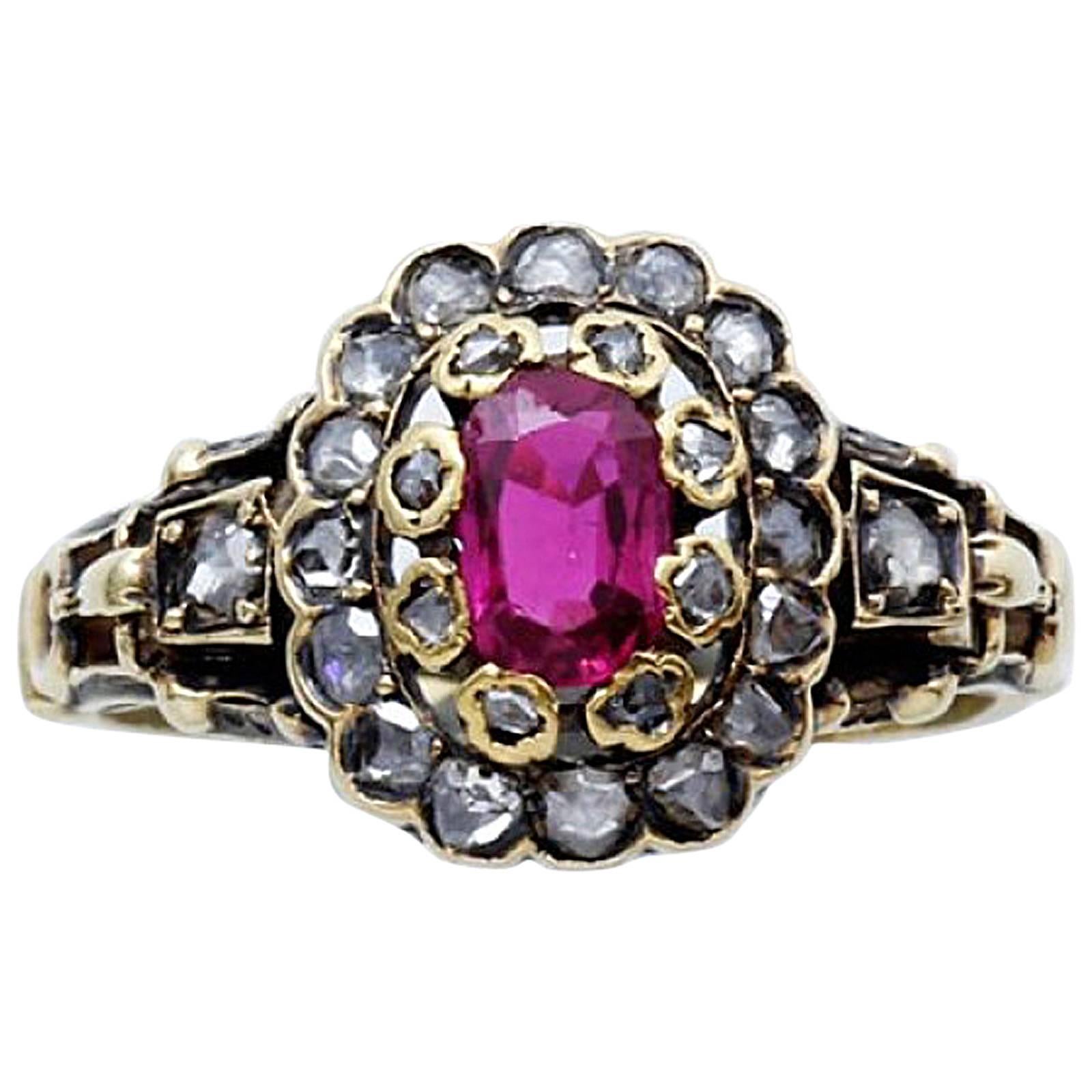 An oval ruby mounted in gold ring surrounded by rose cut diamond
14k Yellow gold 585
Mid-19th Century.

Ring size: 3 3/4.
