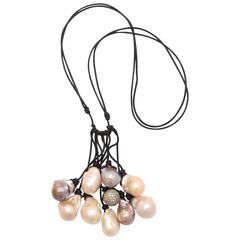 Necklace of Pastel Baroque Freshwater Pearls Accented with a White Sapphire Bead