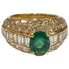 Yellow gold Cartier ring set with an emerald and diamonds.