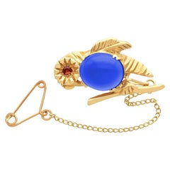 Antiguo broche de oro amarillo de 1910 con forma de pájaro de 2,94 ct de cuarzo teñido y granate de hessonita