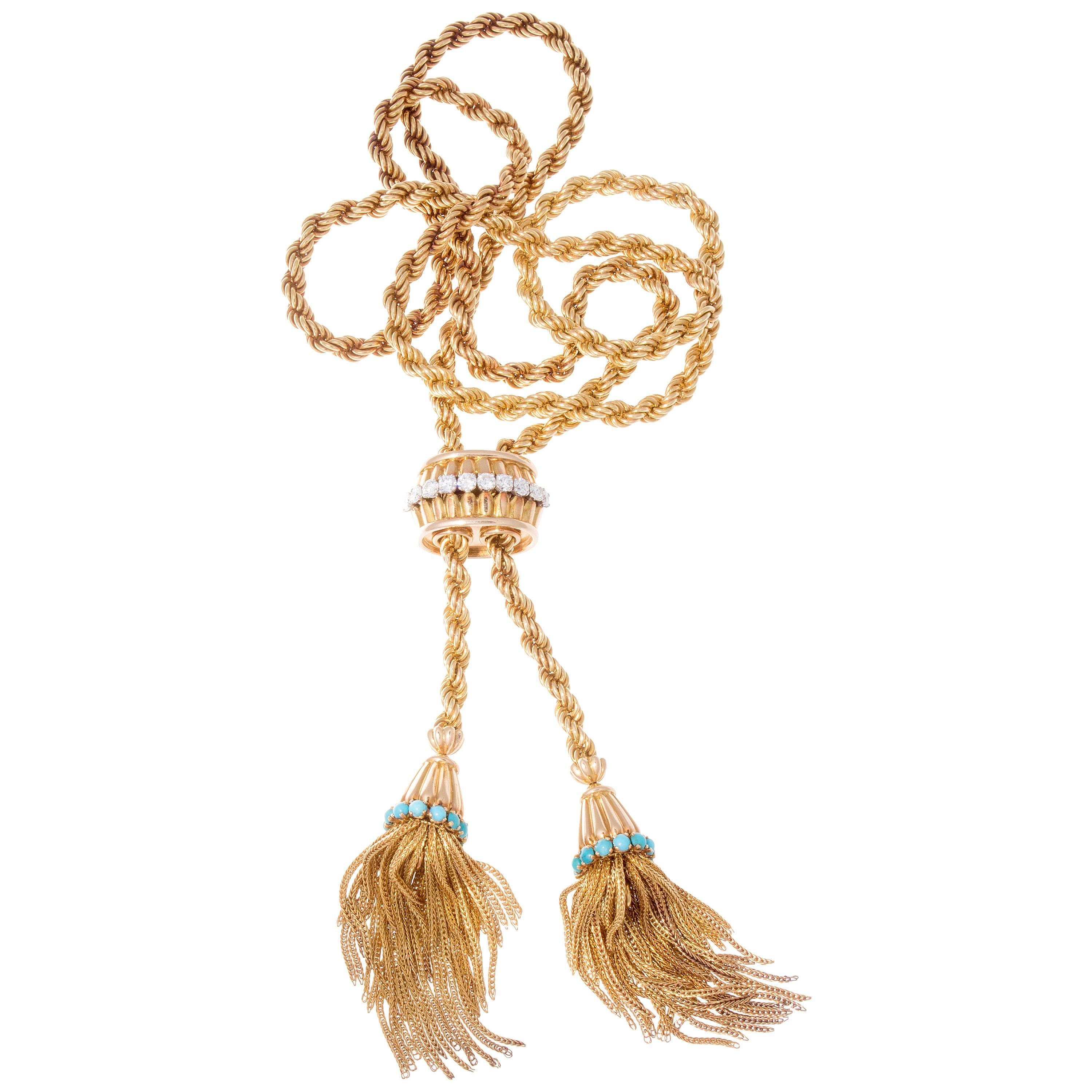 A fabulous and lively creation that brings movement to an inanimate object. The 18k gold necklace has been fashioned into a rope motif that cascades down to the free flowing tassels at the end. Featuring perfectly colored turquoise and clean white