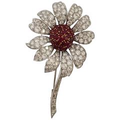 Platinum flower set with brilliants and rubies.