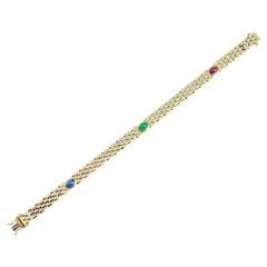 Bracciale vintage con smeraldo, zaffiro e rubino cabochon in oro giallo