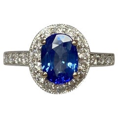 2.20 Carat Vivid Blue Sapphire and Diamond 18 Karat Gold Oval Cluster Halo Ring