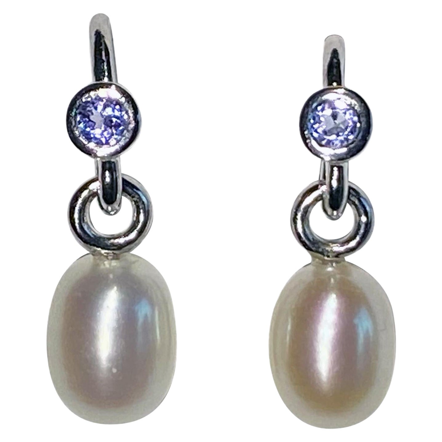 A Pair of Pearl Dangle Earrings Accented with Tanzanites. For Sale