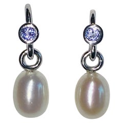 A Pair of Pearl Dangle Earrings Accented with Tanzanites.