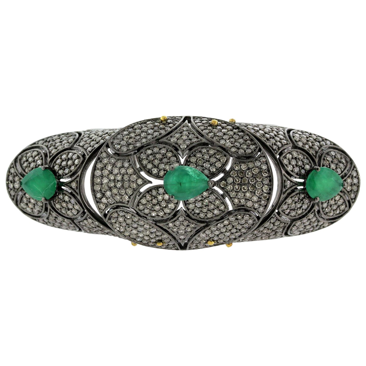 Designer Knuckle Ring with Emerald Stones Surrounded by Pave Diamonds For Sale