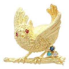 Broche inglés de oro amarillo con pájaro de zafiro rubí turquesa diamante, 1971