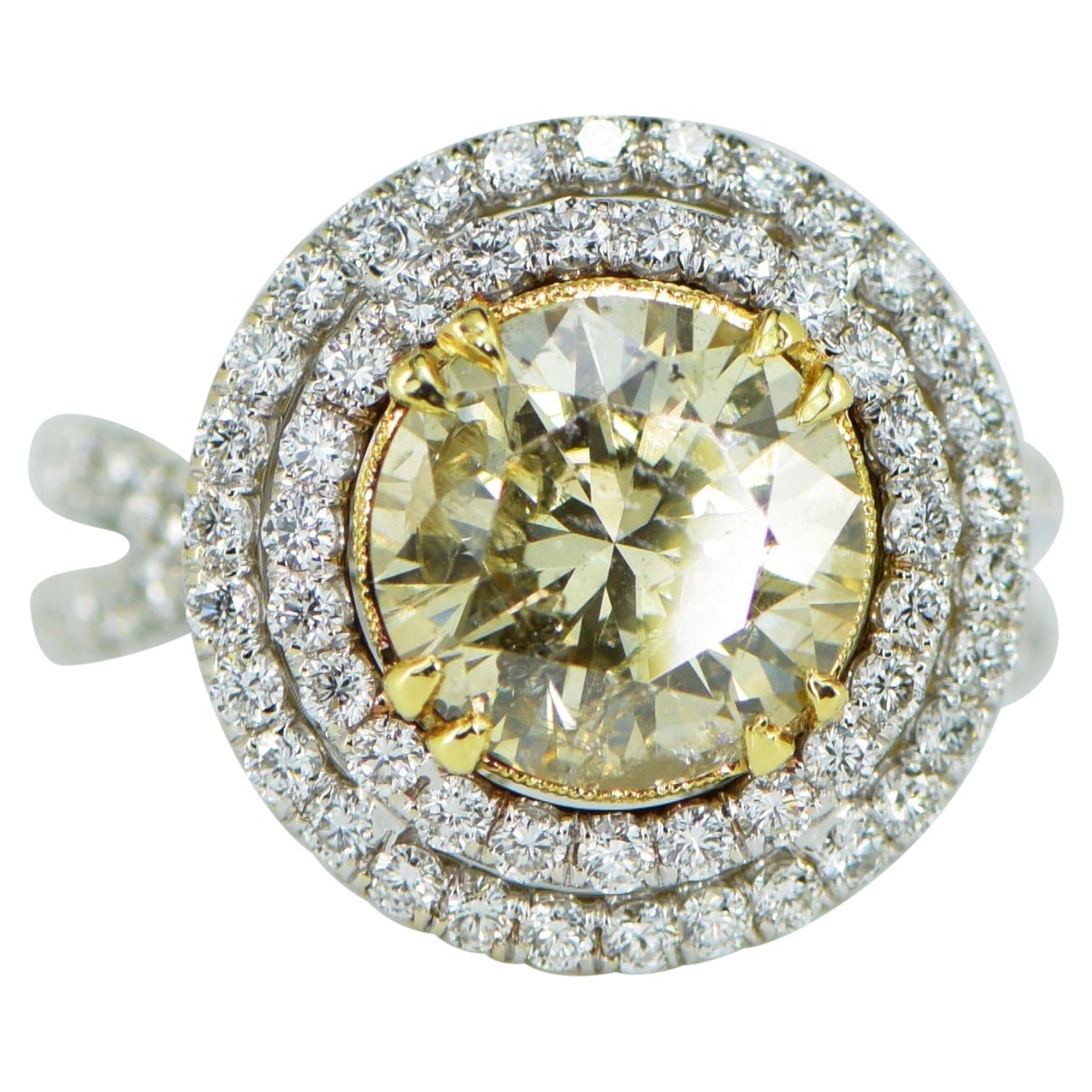 This magnificent yellow diamond ring is a true masterpiece, expertly crafted in 18 karat white gold. The stunning 3.10ct center diamond radiates with a warm and vibrant yellow hue, beautifully complemented by the sparkling 1.27ct of white diamonds.