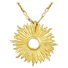 18 Karat Gold Handmade Sunburst Pendant Hanging on a 18 Karat Gold Chain