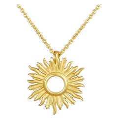 18 Karat Gold Small Sunburst Pendant Hanging on a 18 Karat Gold Chain