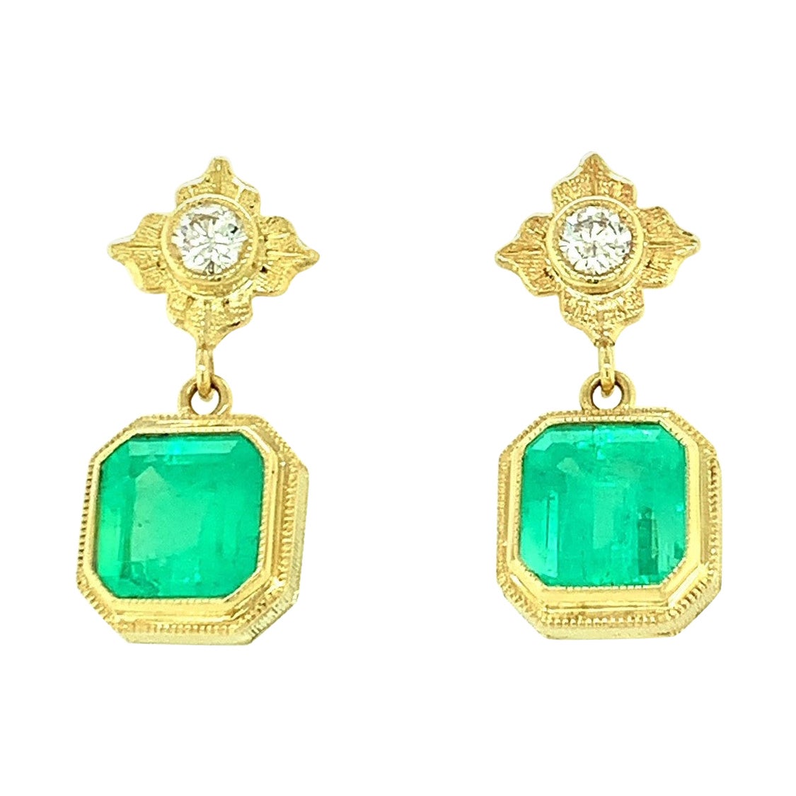 These handmade emerald and diamond earrings are a statement of classic elegance that will have you turning heads wherever you go. Two gorgeous square-cut emeralds have been set in rich 18k yellow gold bezels to show off their fine color and quality.