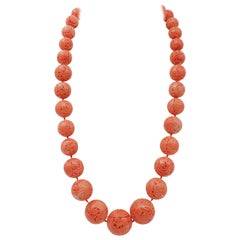 Vintage collectible necklace made with large engraved coral spheres