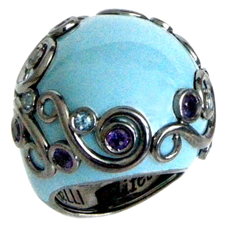 Bague ronde en argent émaillé de couleur turquoise avec améthyste et topaze bleue