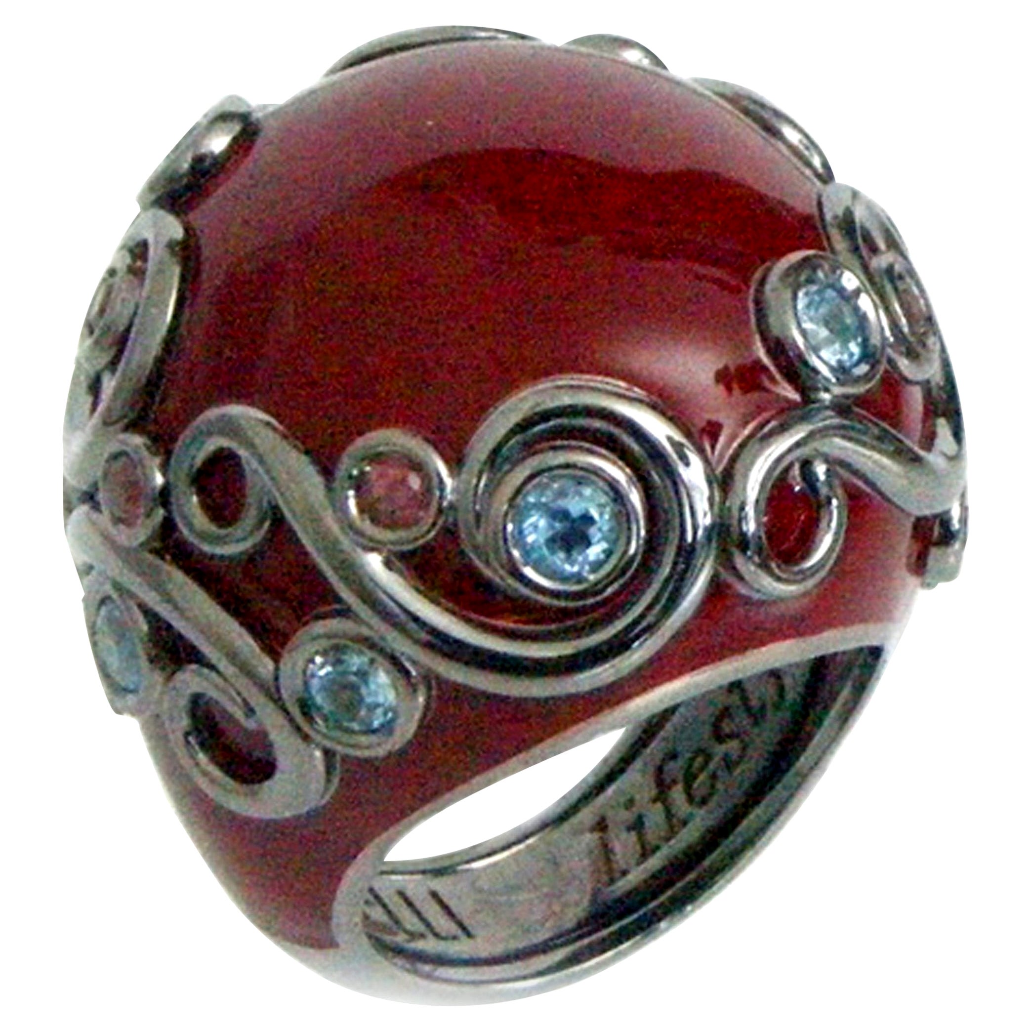 Bague ronde en argent émaillé de couleur rouge avec  Rodolite et topaze bleue