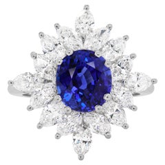 3.09 Carat Royal Blue Oval Sapphire and Diamond Platinum Cluster Ring, 1984