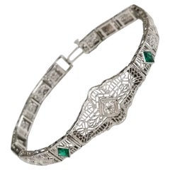 Vintage Art Deco Filigree "Belly" Bracelet in 14 Karat Gold with Diamonds and Emeralds