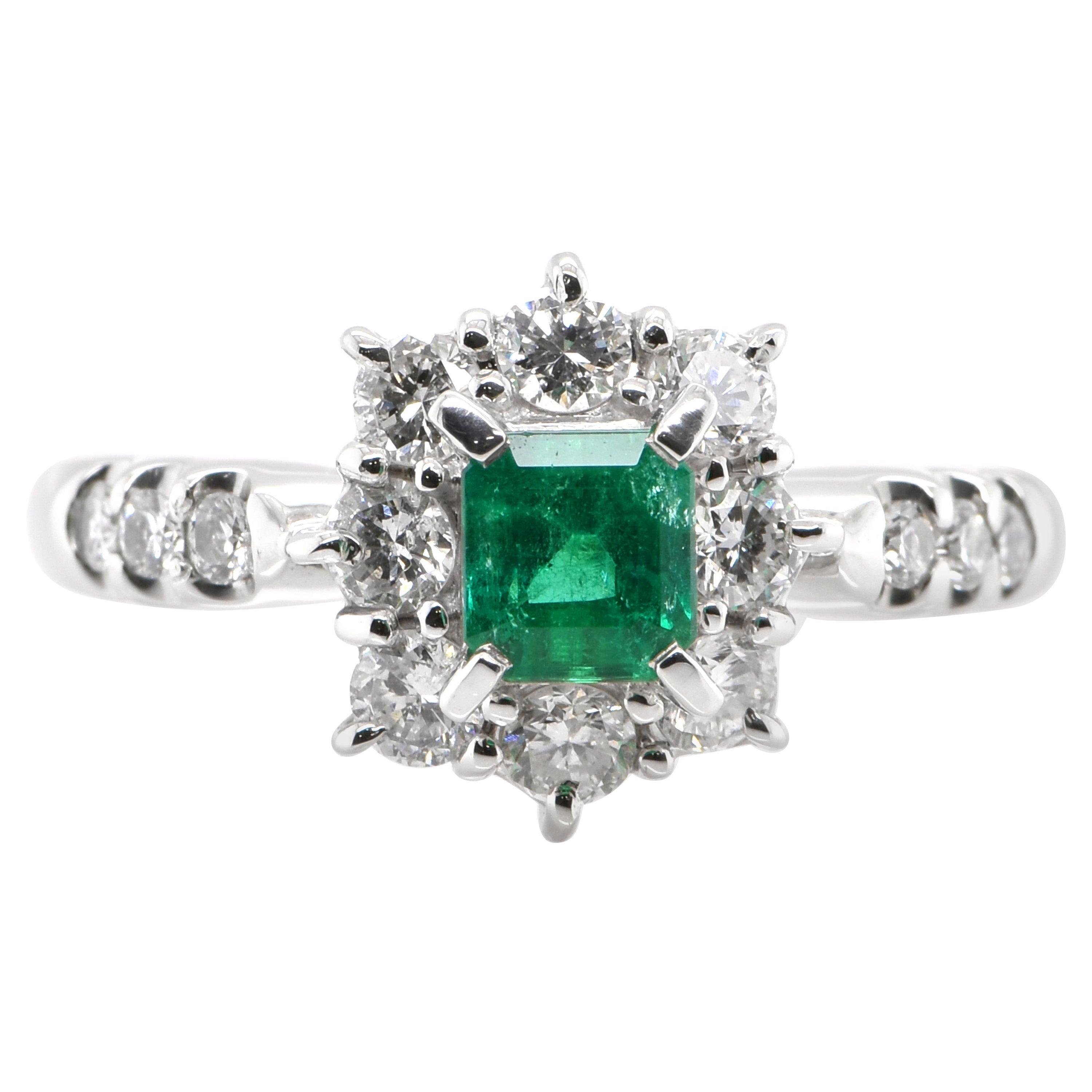 0.48 Carat Natural Emerald and Diamond Halo Ring Set in Platinum
