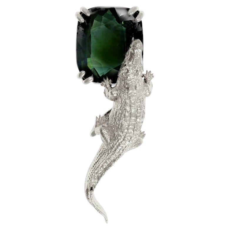 Broche contemporaine en or blanc dix-huit carats avec saphir vert