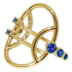 Interlocking Geometry Oval Ring with Sapphires and Diamonds in 18 Karat Gold