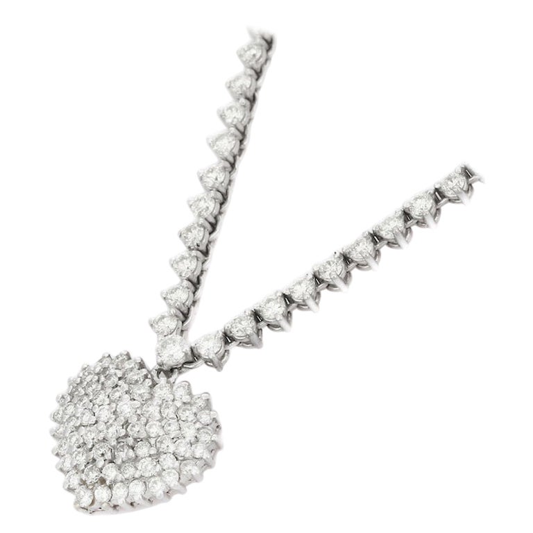  Stunning 5.5 CTW Diamond Heart Necklace in 18K Gold studded with round cut diamond. This stunning piece of jewelry instantly elevates a casual look or dressy outfit. 
April birthstone diamond brings love, fame, success and prosperity.
Designed with