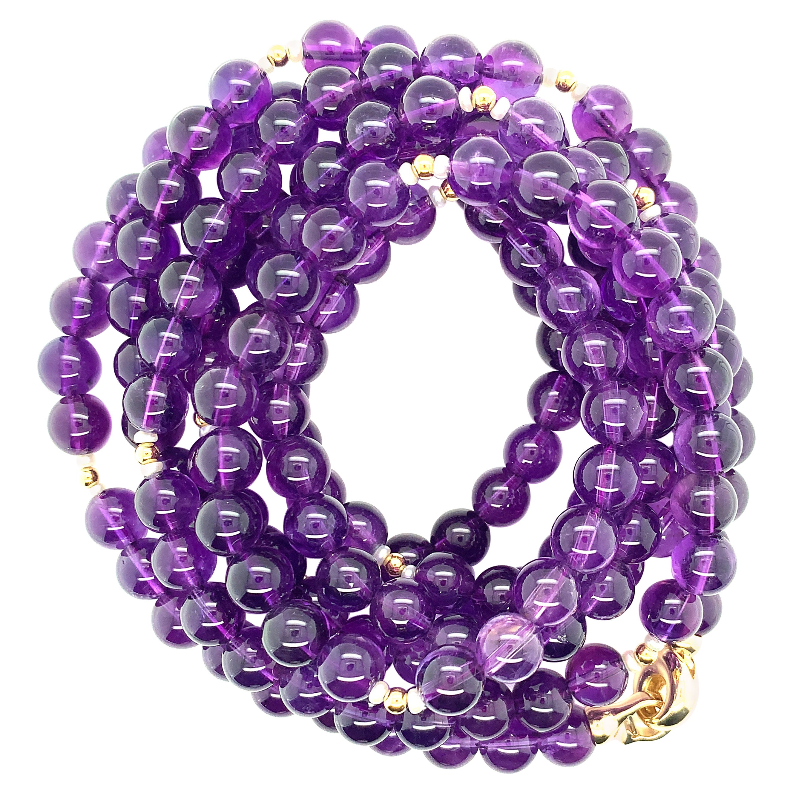 This versatile strand of richly colored amethyst beads can be worn in several different ways! Fine quality 8.00mm round amethyst beads have been strung with 18k yellow gold spacers and tiny accent pearls in an elegant necklace that measures 51