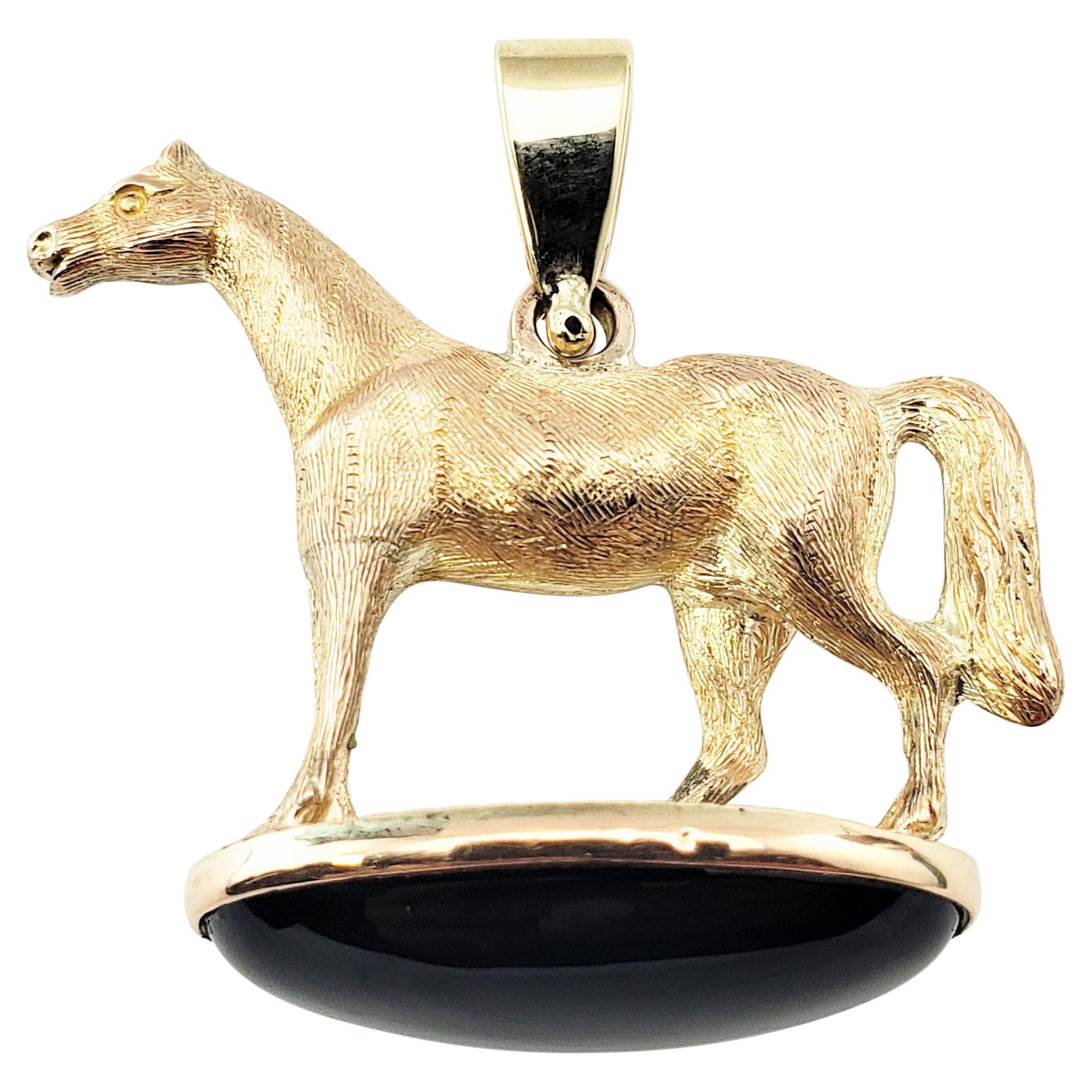 14 Karat Yellow Gold and Onyx Horse Pendant For Sale