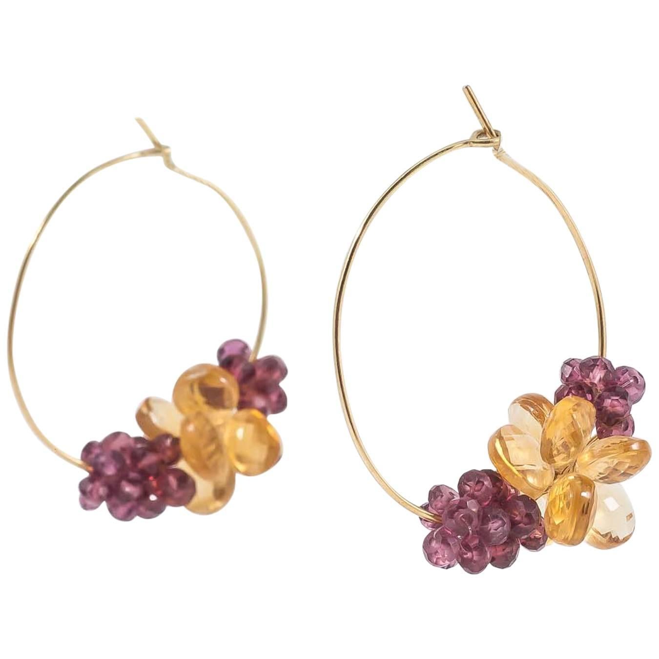 Elegantly contemporary in design, these Donna Brennan 18ct Gold Citine & Rhodolite Garnet Hoop Earrings are handcrafted in her London studio. Light and luscious, these earrings move easily from day to evening wear.

Donna's work typically features