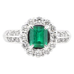 0.69 Carat Natural Emerald and Diamond Engagement Ring Set in Platinum